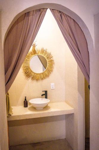 a bathroom with a sink and a mirror at Co404 Oaxaca - Coliving Coworking in Oaxaca City