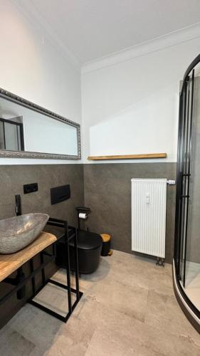 a bathroom with a sink and a bath tub at Paulus Living in Halle an der Saale