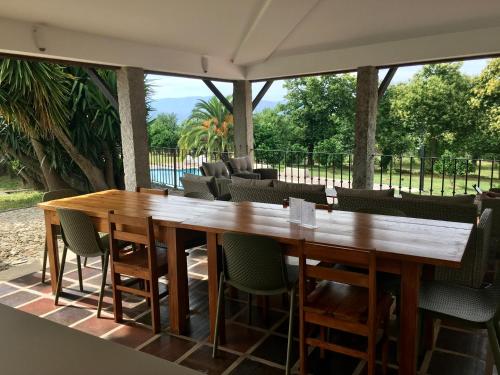 a large wooden table and chairs on a patio at The Hideaway at Quinta de Moçamedes - Suites & Apartments in Vouzela