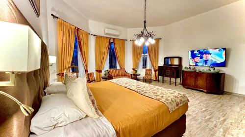 a bedroom with a bed and a tv in it at Resort Termas de Panimávida - Hotel & Spa in Panimávida