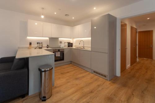 a kitchen with white cabinets and a counter top at Fantastic 2 Bedroom Apartment in Central Ashford in Ashford