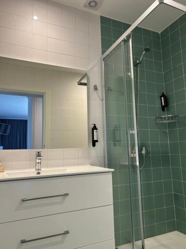 a bathroom with a sink and a glass shower at Herdade do Serra in Ervidel