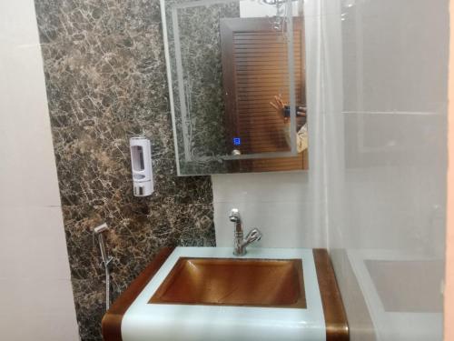 a bathroom with a sink and a shower at Hotel New Mandpam in Orai