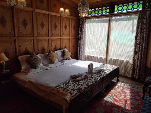 a person laying on a bed in a bedroom at Heevan in Srinagar