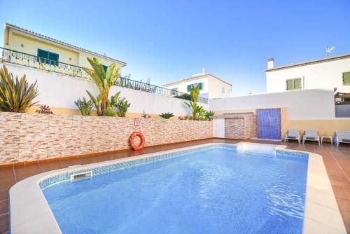 a swimming pool in the backyard of a house at Vila Alcantarilha by MTPhomes in Alcantarilha