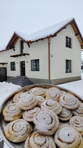 a tray of donuts in front of a house at Casa Aida in Peşteana