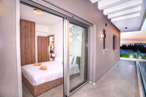 a bedroom with a bed and sliding glass doors at Celeste Suites in Limassol