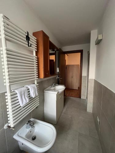 a bathroom with a white toilet and a sink at Osteria Locanda Veneta in Mirano