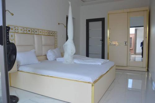 a bedroom with a bed with a statue on it at Villa Keur Carla in Niangol