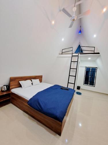 a bedroom with a bed and a ladder in it at Mung Kham Stays in Jorhat