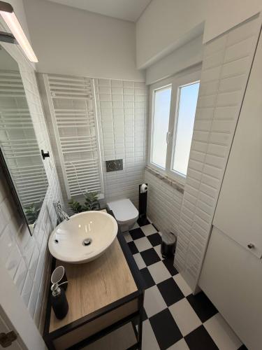 a bathroom with a sink and a toilet at Estoril by the Sea in Estoril