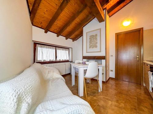 a bedroom with a desk and a bed and a table at La Maison Pilly in Sondalo