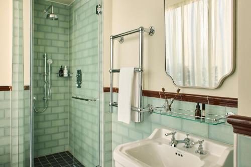 a bathroom with a sink and a shower at The Hoxton, Dublin in Dublin