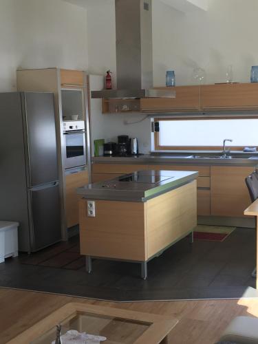 a kitchen with an island in the middle of it at Ferienwohnungen Ellmer in Flachau