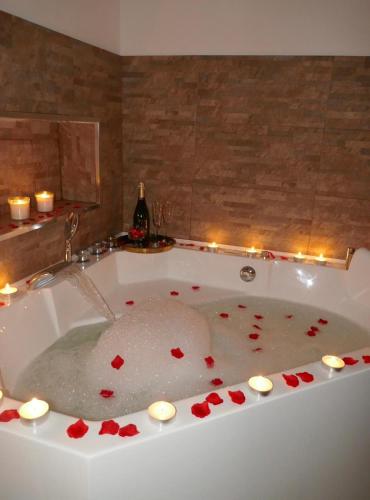 a bath tub filled with red hearts and candles at Villa Iliana in Lucca