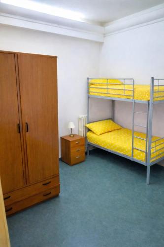 a room with two bunk beds and a cabinet at Davids Home in San Vito dei Normanni