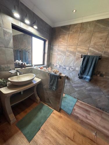 a bathroom with a sink and a large shower at 20 at Meul in Potchefstroom