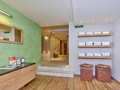 a bathroom with a counter and shelves with towels at Alp Resort Tiroler Adler in Sölden