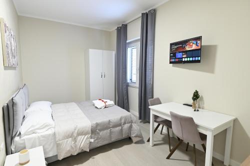 a bedroom with a bed and a desk and a table at MyRoom in Ariano Irpino