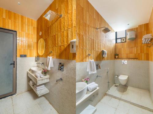 a bathroom with a sink and a toilet and a mirror at Shivaangan By Soma Estates in Udaipur
