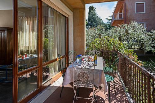 a table and chairs on the balcony of a house at EDDA - Regarda Travel in Lazise