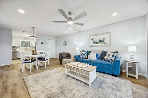 a living room with a blue couch and a table at 4F Amelia Landings in Fernandina Beach