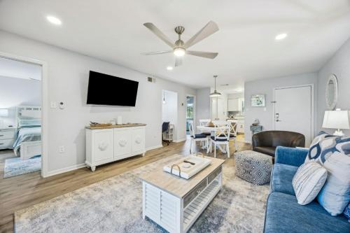 a living room with a blue couch and a tv at 4F Amelia Landings in Fernandina Beach