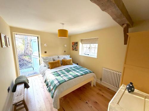 a bedroom with a bed and a window at Orchard Barn next to Bewl Reservoir, Ticehurst in Ticehurst