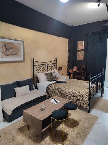 a bedroom with a bed and a couch and a table at Anatolia in Veria