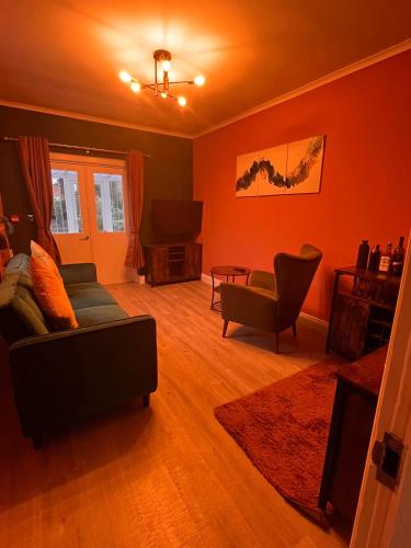 a living room with a couch and a table at Stylish 2Bed Ground Floor Flat with Private Garden in Weston-super-Mare