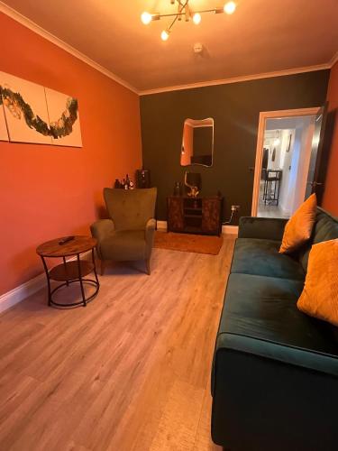 a living room with a couch and a table at Stylish 2Bed Ground Floor Flat with Private Garden in Weston-super-Mare