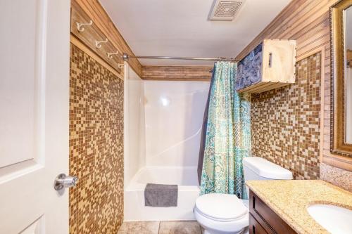 a bathroom with a toilet and a shower at Gulf Shores Barefoot Bliss in Gulf Shores