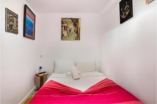a bedroom with a bed with a red blanket at Studio M in Tangier