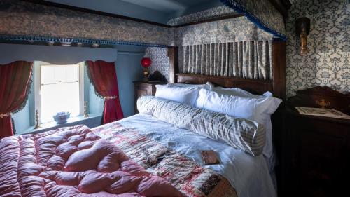 a bedroom with a large bed in a room with wallpaper at Orkney Retreats Island Farmhouses & Cottages in Sanday