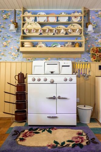 a kitchen with a white stove in a room at Orkney Retreats Island Farmhouses & Cottages in Sanday