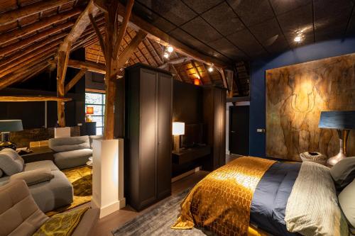 a bedroom with a large bed in a room with blue walls at Luxe Veluwse Bosrand Suite met Jacuzzi en Zwembad in Lunteren