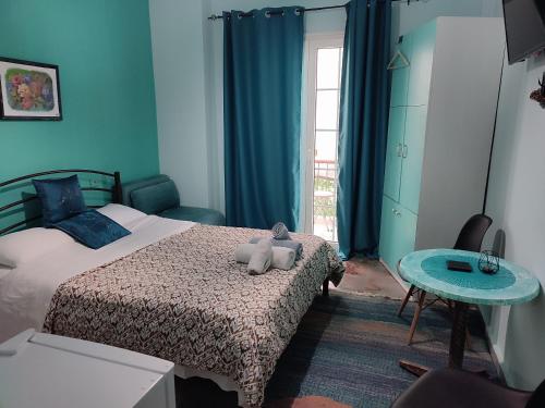 a bedroom with a bed with a teddy bear on it at Blue Dreams in Veria
