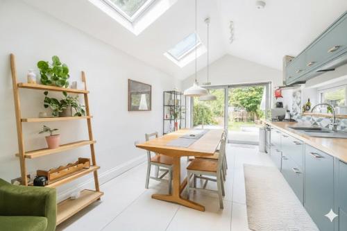 a kitchen with a wooden table and a dining room at Quiet Devon Luxury Escape 3-Bed in Honiton