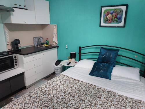 a bedroom with a bed with a blue wall at Blue Dreams in Veria