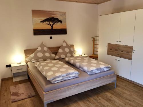 a bedroom with two beds and a tree at Ferienwohnung Leni mit Balkon in Maroldsweisach