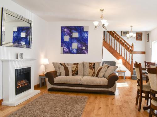 a living room with a couch and a fireplace at Wesley Old Hall House in Bacup