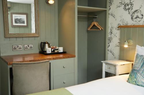 a bedroom with a bed and a desk in a room at Castle Inn by Greene King Inns in Bakewell