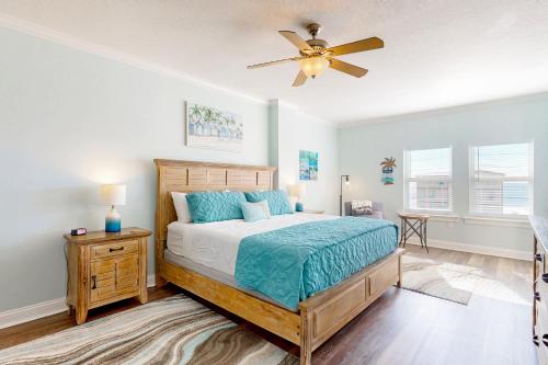 a bedroom with a bed and a ceiling fan at Paradise Shores 305 in Mexico Beach