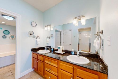 a bathroom with two sinks and a large mirror at Paradise Shores 305 in Mexico Beach