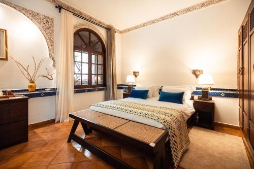 a bedroom with a bed and a window at Dar Arraha Ouirgane in Ouirgane