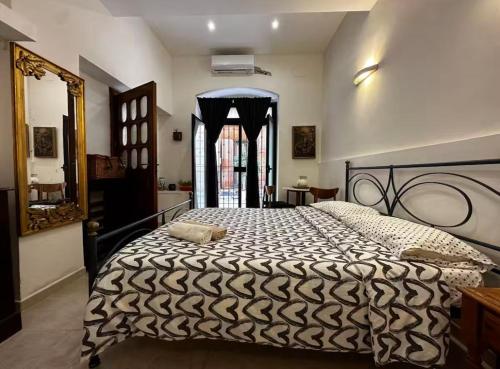 a bedroom with a black and white bed and a window at Guiscardo Suites in Bari