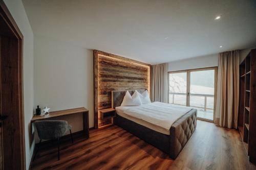 a hotel room with a bed and a window at Kleinberg Chalet in Filzmoos