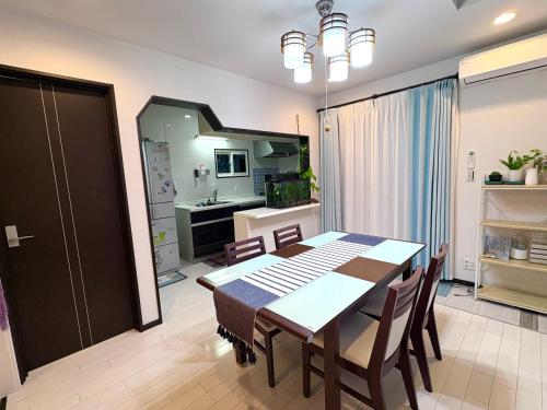 a kitchen and dining room with a table and chairs at sakuraの家 in Tokyo