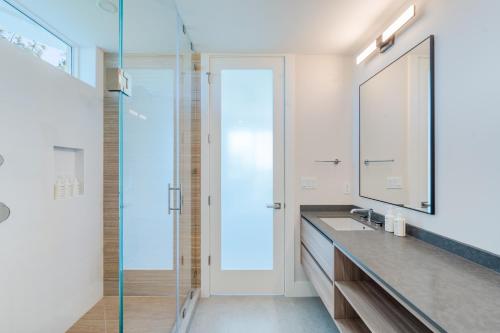 a bathroom with a sink and a mirror at Point West Premier Rentals in West Bay