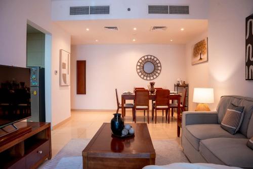 a living room with a couch and a table at Stylish 1BR close to Metro and Dubai Marina in Dubai